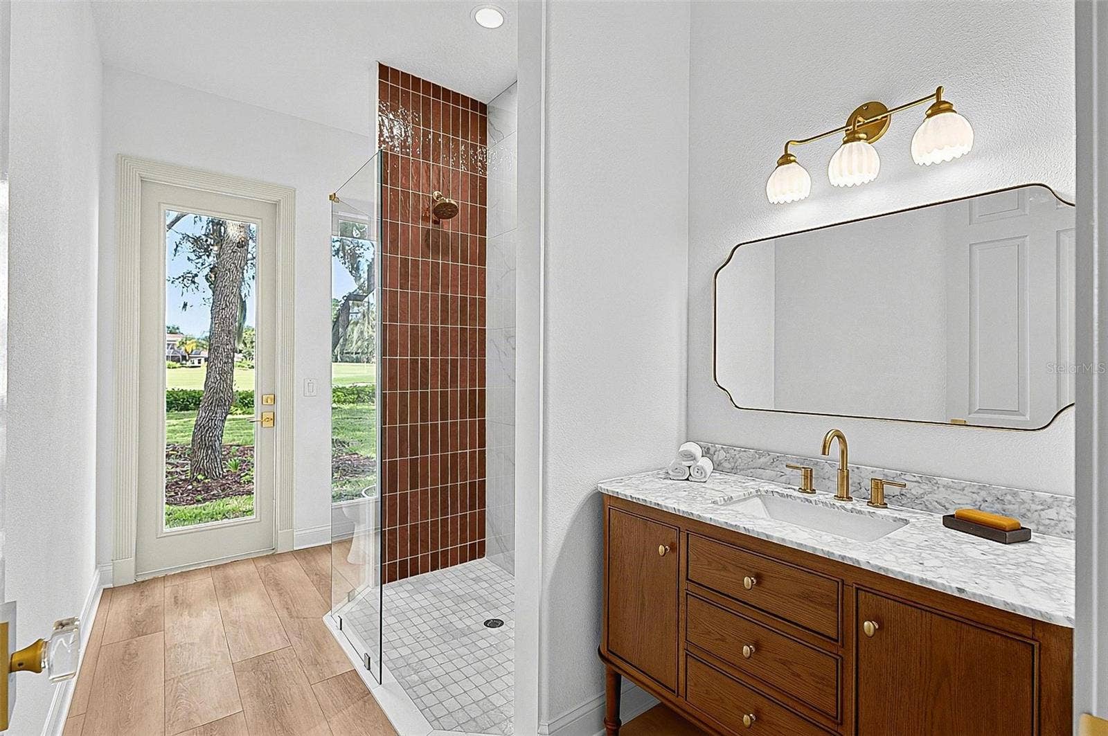 17 GRANDVIEW DRIVE, Palm Coast, FL 32137 Guest 2nd bathroom with tile shower, stone top wood vanity and outside door entrance