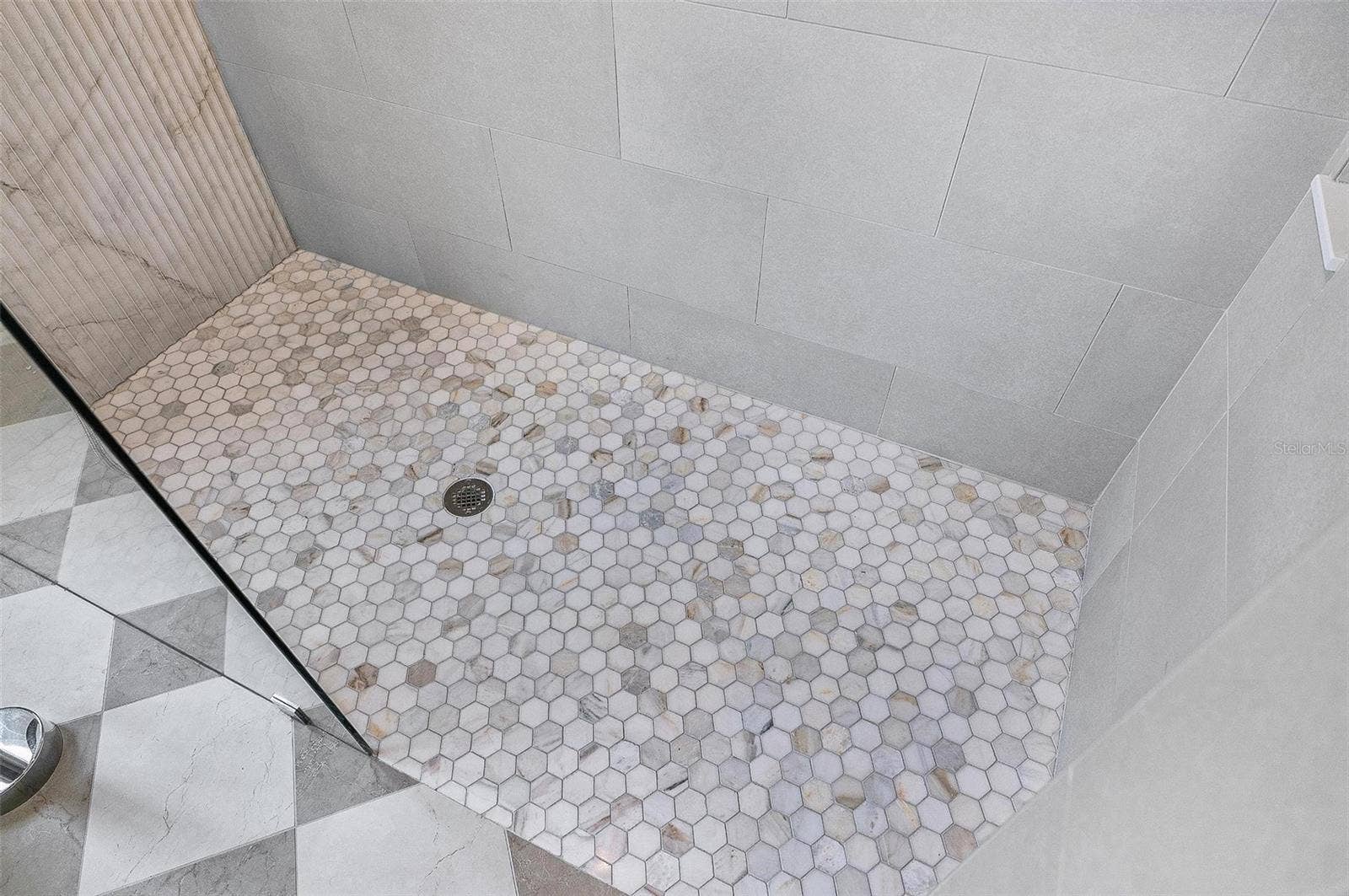 17 GRANDVIEW DRIVE, Palm Coast, FL 32137 Stunning tiled shower with pebble tile floor and glass