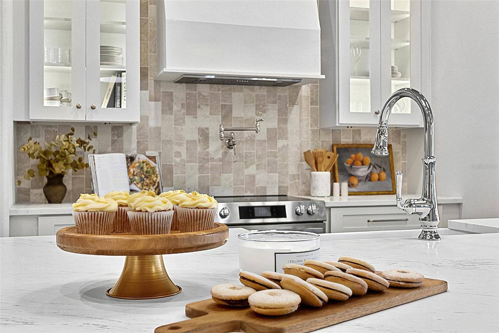17 GRANDVIEW DRIVE, Palm Coast, FL 32137 Elegant Centerpiece Kitchen Island with crafted wall of tile and lighted window cabinets