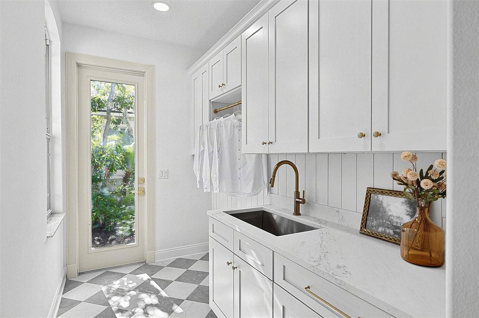 17 GRANDVIEW DRIVE, Palm Coast, FL 32137 Very spacious laundry room, sink, cabinets, quartz countertops and outside entrance