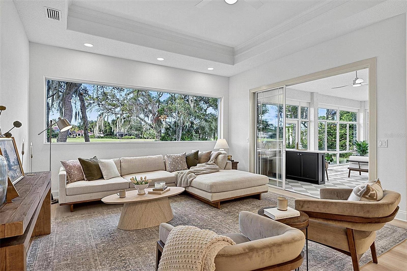 17 GRANDVIEW DRIVE, Palm Coast, FL 32137 Family room with Stunning views through wall of window looking out to backyard and golf course with triple sliders onto the solarium