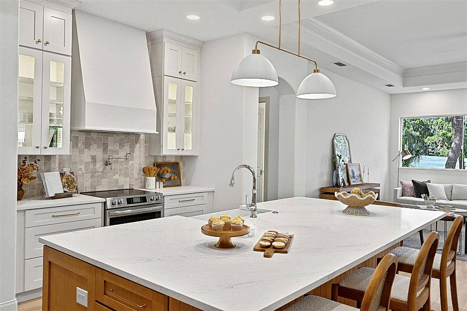 17 GRANDVIEW DRIVE, Palm Coast, FL 32137 Elegant Centerpiece Kitchen Island with crafted wall of tile and lighted window cabinets