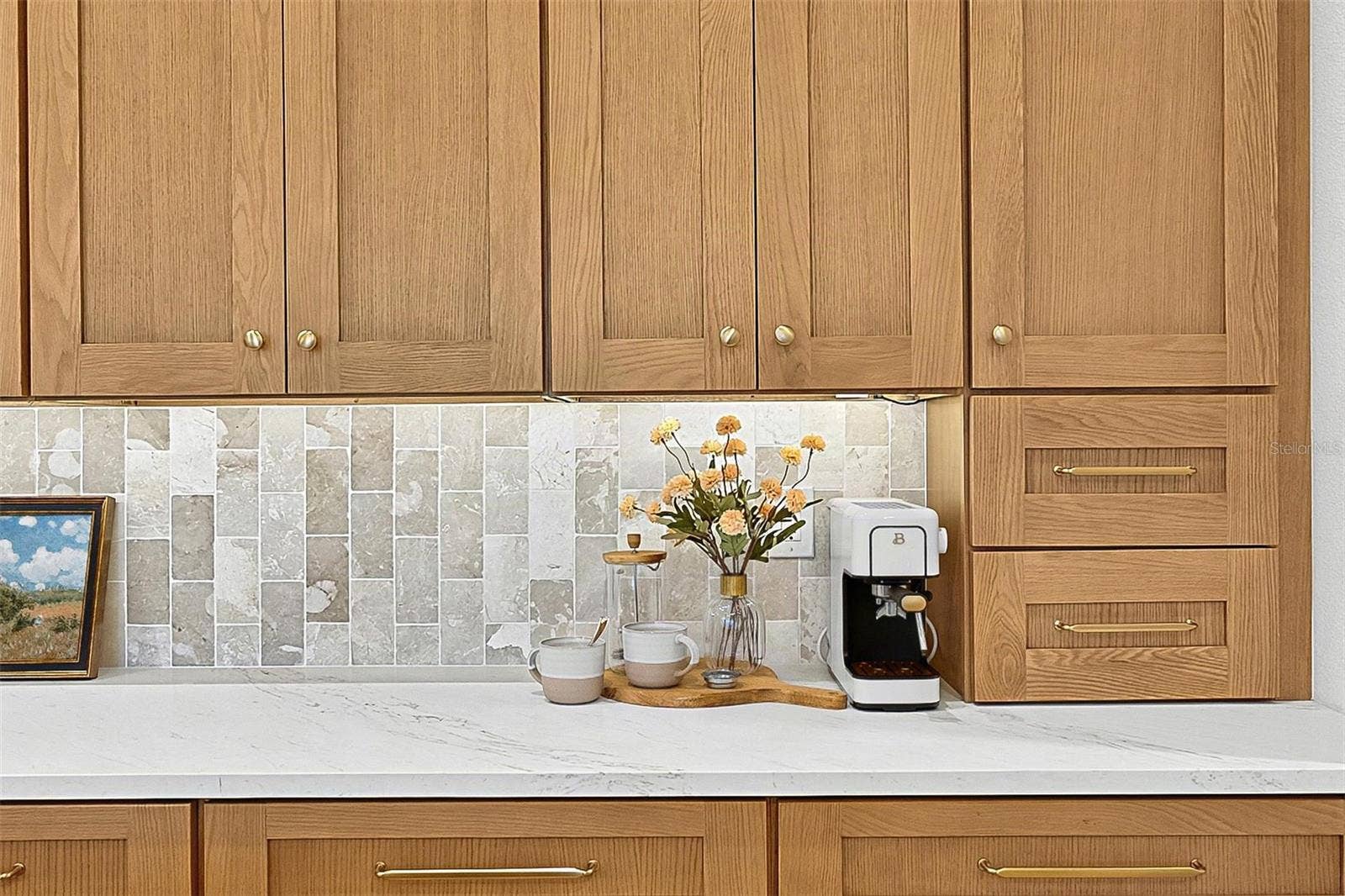 17 GRANDVIEW DRIVE, Palm Coast, FL 32137 Full wall of Custom Wood soft close cabinets with under-mount lighting against the stunning tile and quartz countertops