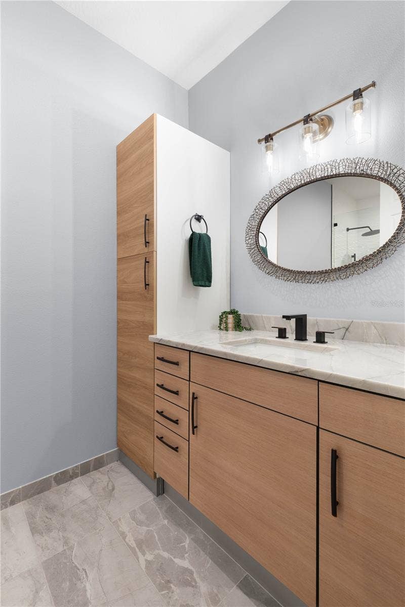 A fresh, modern ensuite bath gives upstairs guests their own beautifully finished space to get ready and feel right at home.
