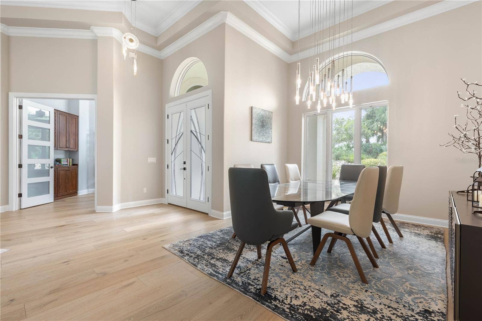 Dinner deserves a little dramavolume ceilings and sculptural lighting give this dining room an impressive presence, ready for everything from intimate dinners to holiday celebrations.