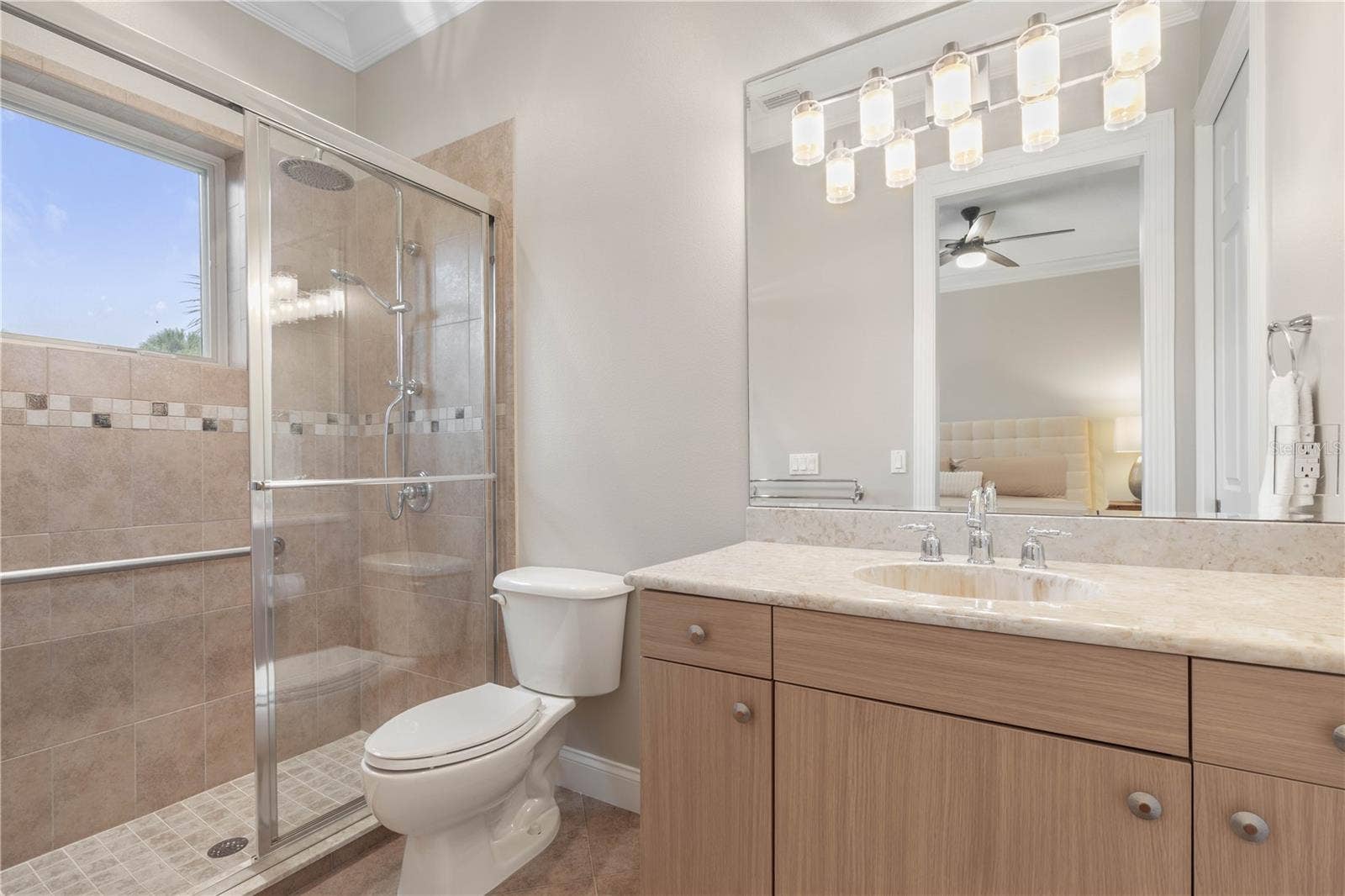 A bright ensuite bath gives Guest Suite #1 its own private space, complete with a walk-in shower and plenty of vanity storage.