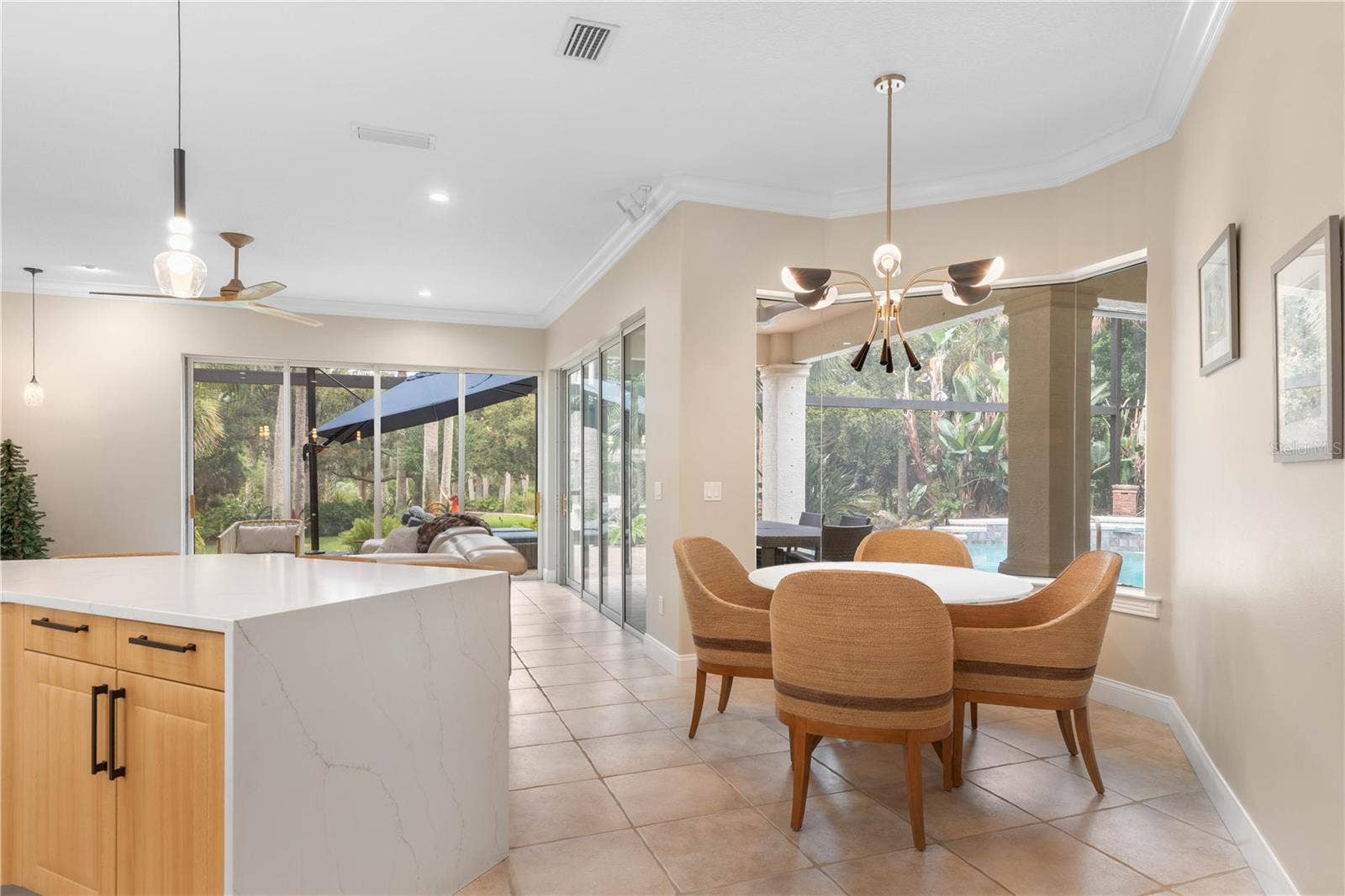 The breakfast nook is made for slow mornings and casual meals, where sunlight and poolside views make even an ordinary cup of coffee feel like a getaway.