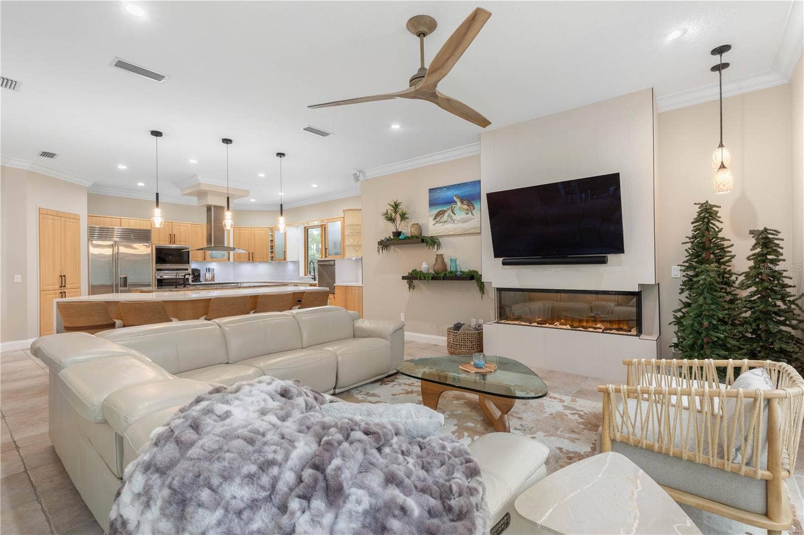 The kitchen flows effortlessly into a relaxed family room, where a sleek contemporary fireplace sets the mood for cozy nights while keeping everyone connected to the heart of the home.