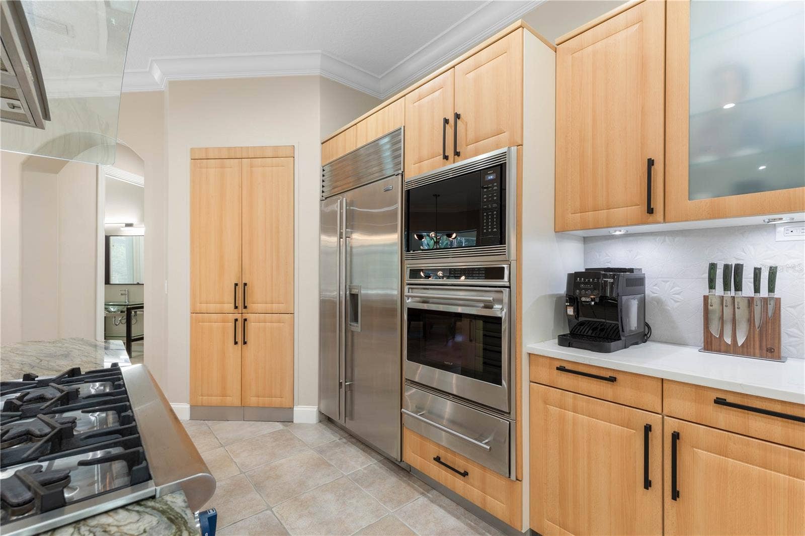 A beautifully integrated appliance wall pairs premium performance with clean European cabinetry, keeping everything within easy reach while preserving the kitchens streamlined design.