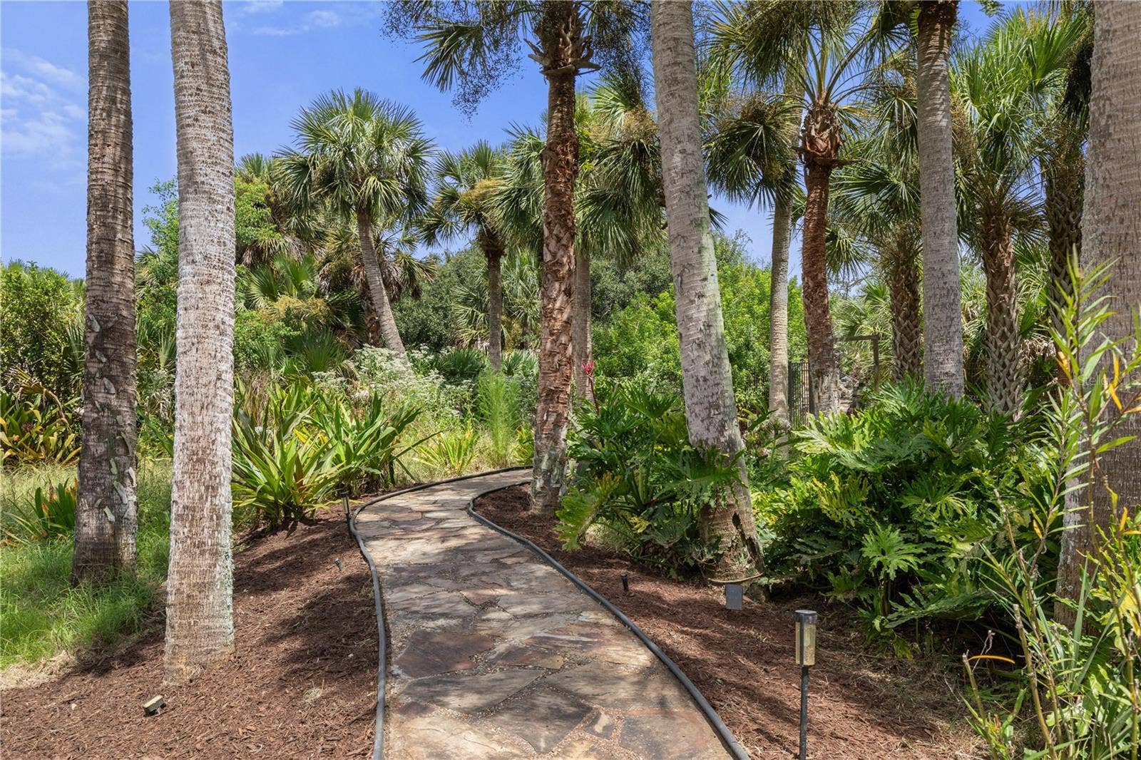 Follow the winding path through lush tropical landscaping, and the story leads to the wateryour private boat dock and canal just ahead.