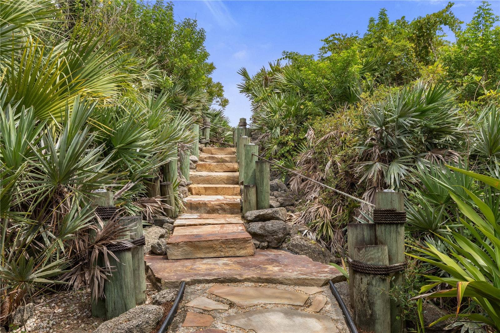 This feels like your own hidden passagestone steps tucked into the tropical landscape, adding a little adventure to every trip down to the water.