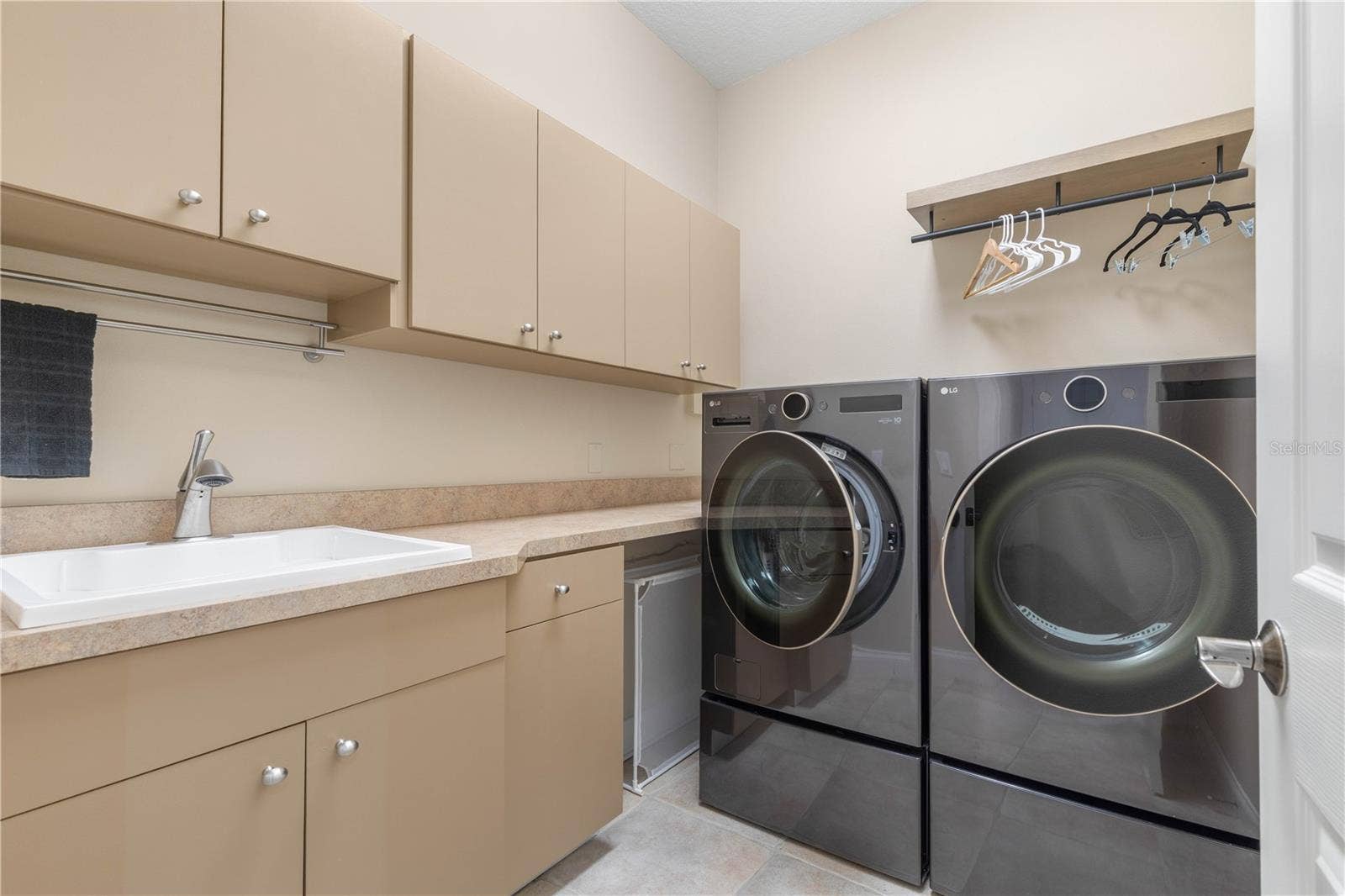 And because everyday life deserves its own well-planned space, the laundry room delivers with a utility sink, generous cabinetry, counter space and room to hang and organize