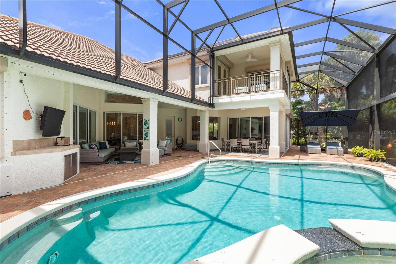 This is where Florida days are meant to unfoldsunlit swims, shaded lounging and leisurely dinners, all within a private screened pool setting made for enjoying life at home