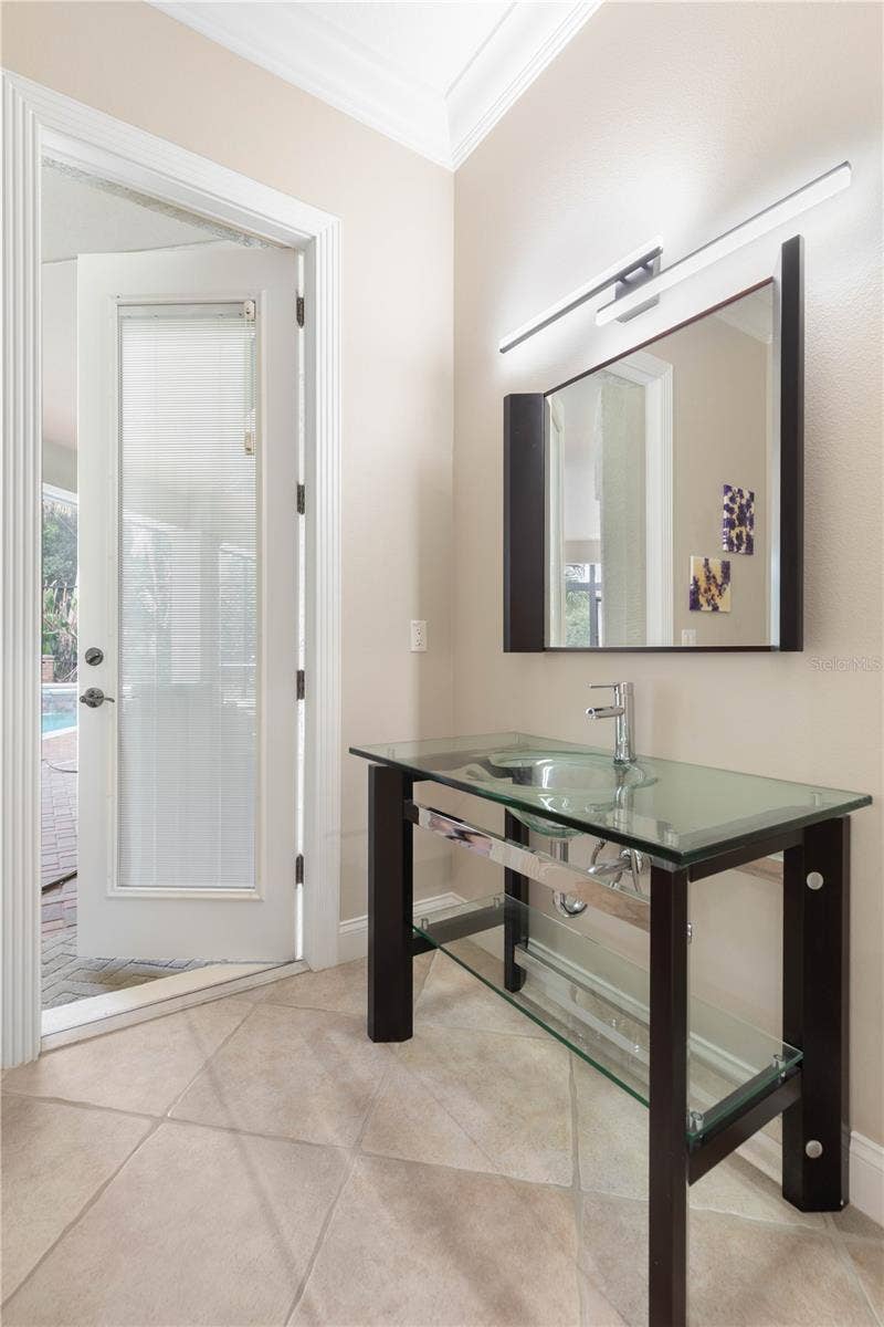 A quick stop without missing the funthis convenient half bath offers easy access from both the pool and inside the home.