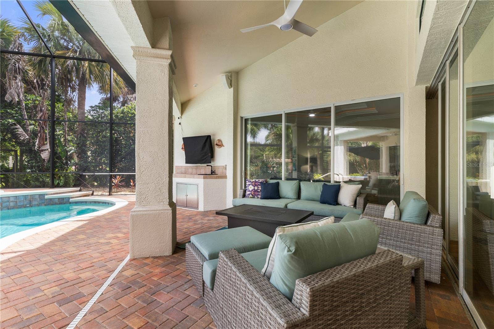 Poolside living gets its own lounge, with a covered seating area made for lingering over cocktails, catching the game, or settling in after a swim.