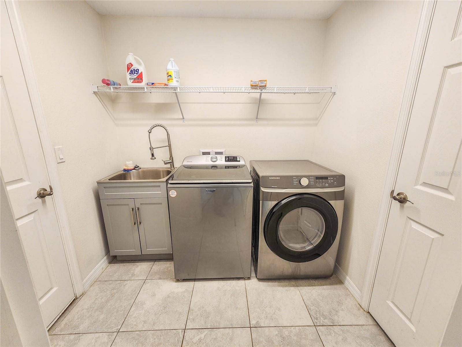 100 BOULDER ROCK DRIVE, Palm Coast, FL 32137 Laundry room with a storage closet.