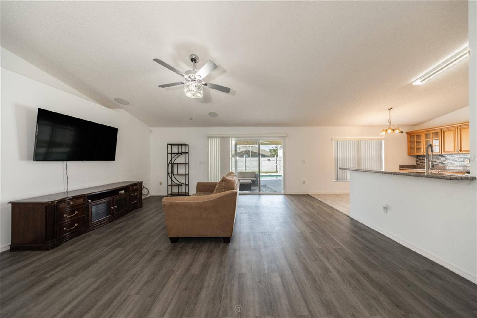 large family room & LVP flooring throughout, except kitchen, foyer & primary bath which are tile
