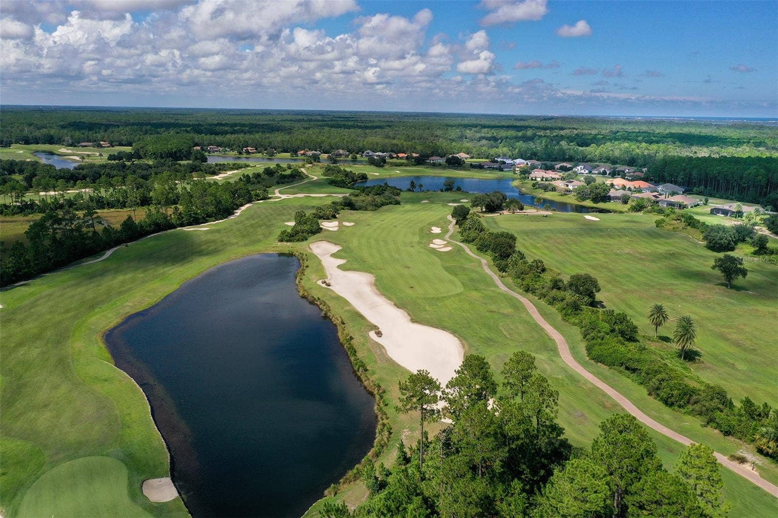 Par 5 hole 18 on the left and Par 4 hole 1 on the right of the Tom Watson designed course, golf privileges included with optional membership