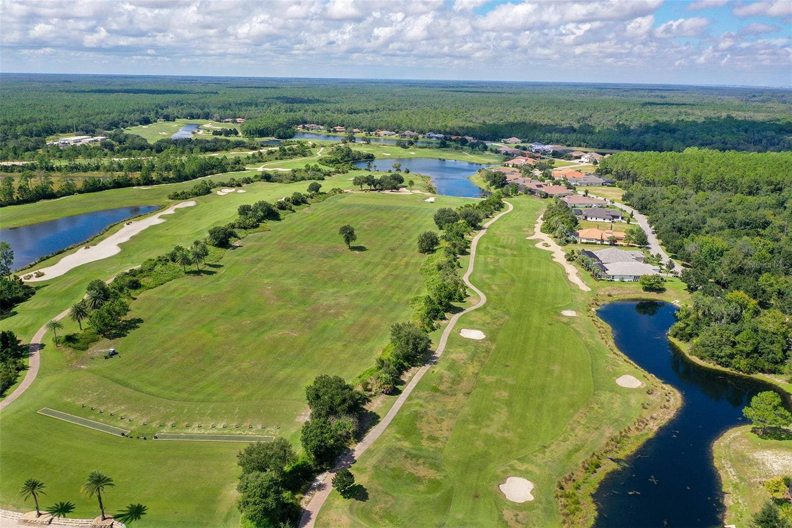 Driving range and hole number 2 on the Tom Watson designed course, golf privileges included with optional membership