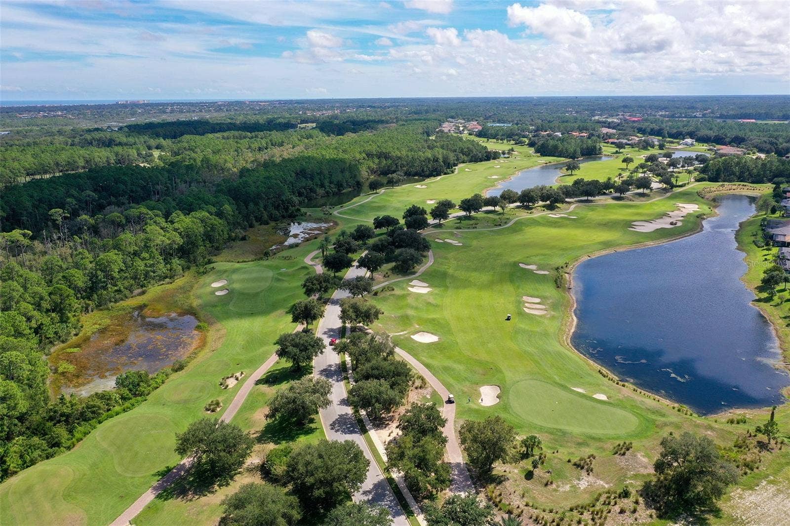 Par 3 hole 3 on the left, Par 5 hole 9 on the right of the Tom Watson designed course, golf privileges included with optional membership