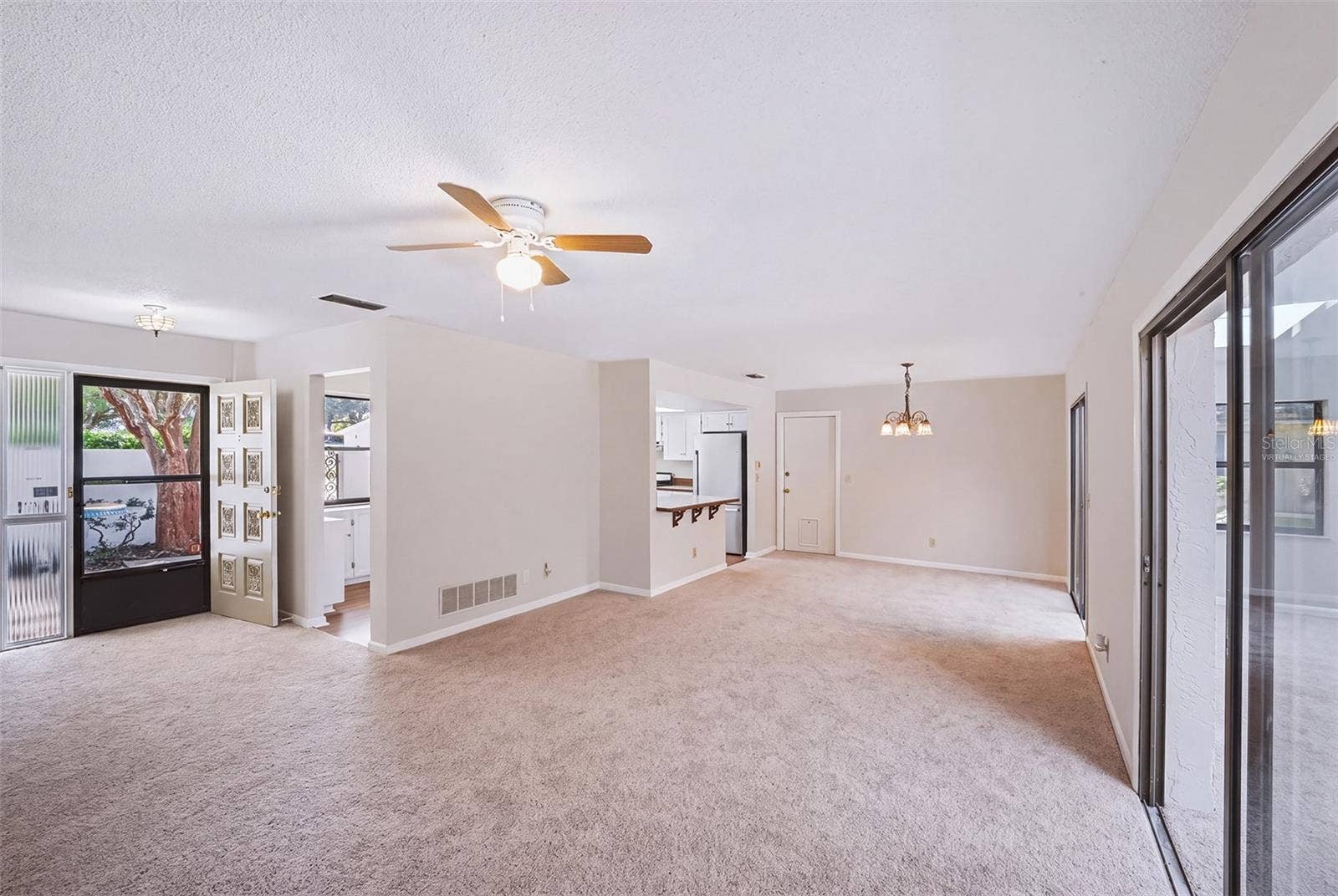 83 FARRAGUT DRIVE, Palm Coast, FL 32137 Virtually staged empty living room/dinette area
