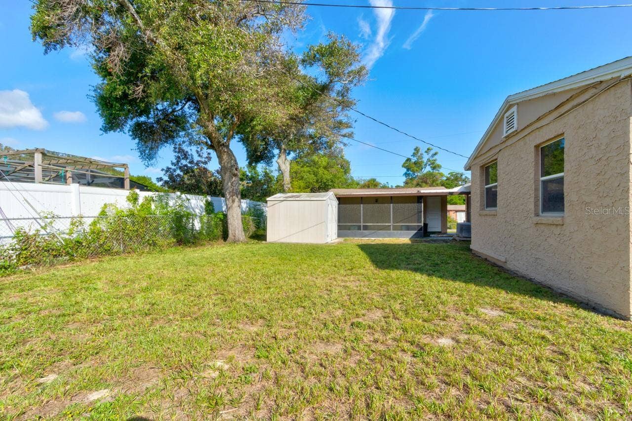 374 PINE ROAD, Ormond Beach, FL 32176 Rear Yard showing shed and screened porch attached to garage