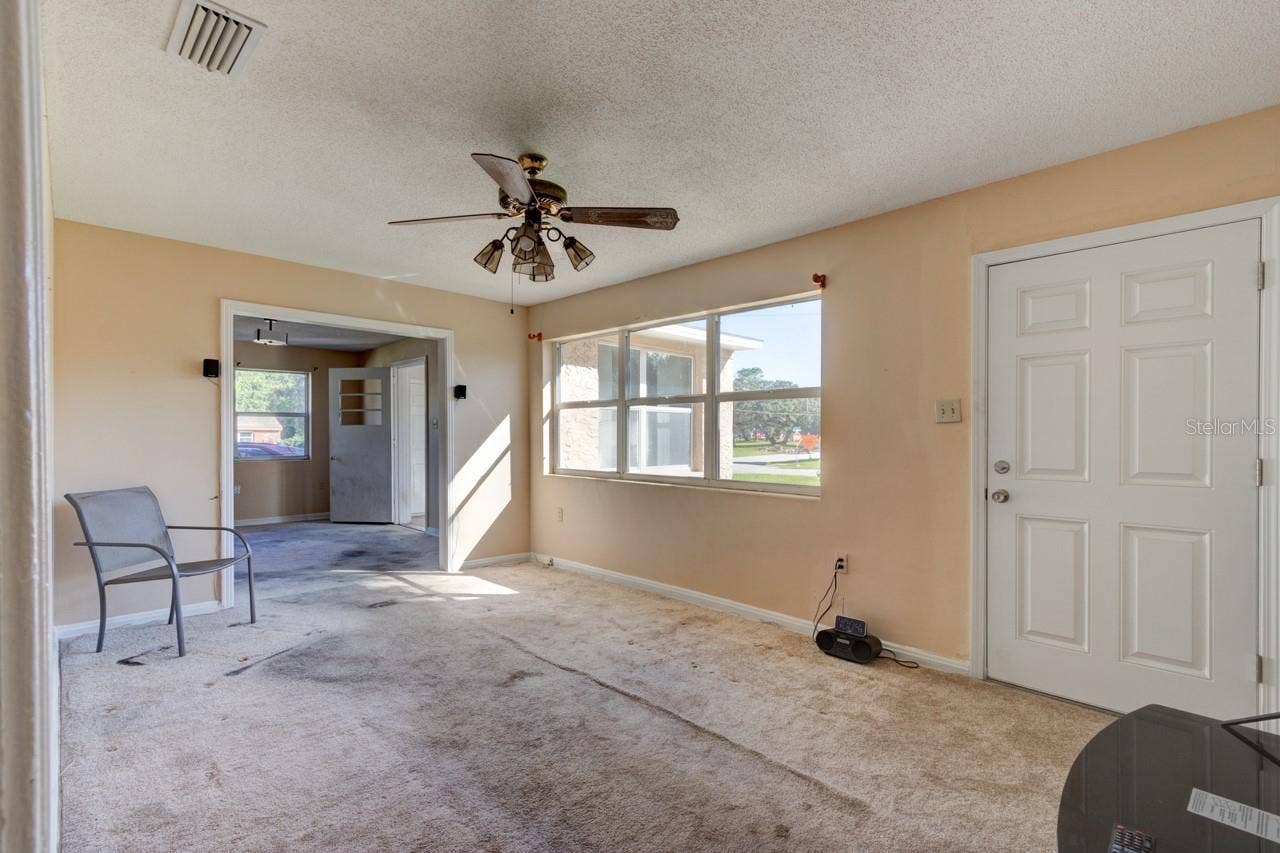 374 PINE ROAD, Ormond Beach, FL 32176 Living room with NE facing window and Front door entry