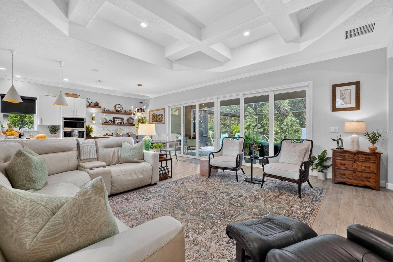 36 NEW WATER OAK DRIVE, Palm Coast, FL 32137 This large great room features a wall of sliders that open up into the private backyard space