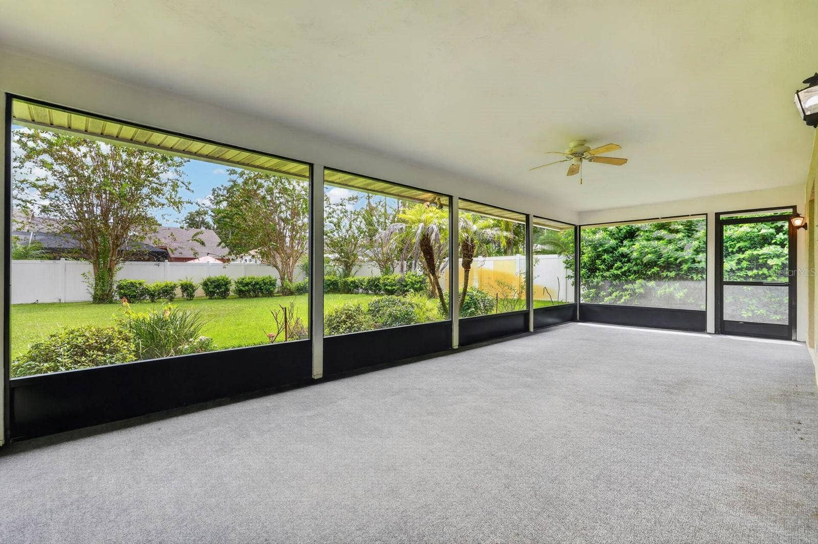 large covered and screened lanai looks out over the peaceful landscape