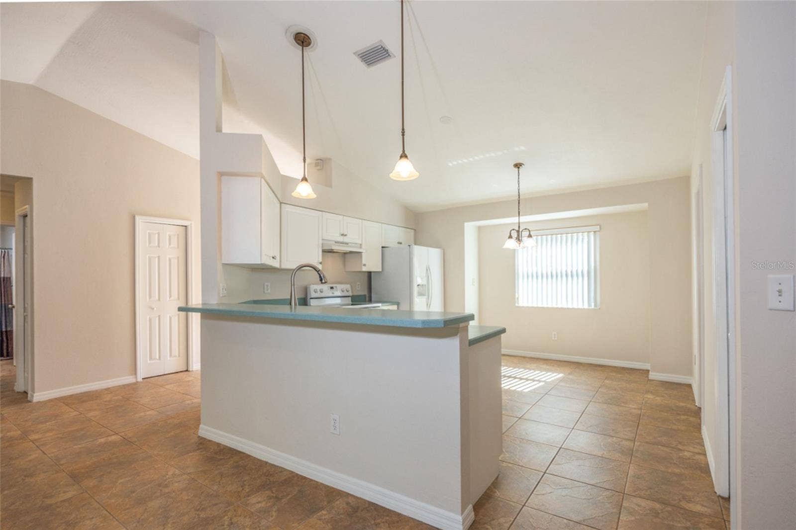 141 BREN MAR LANE, Palm Coast, FL 32137 The kitchen is adjacent to the living room. To the left is a storage closet in the Foyer.