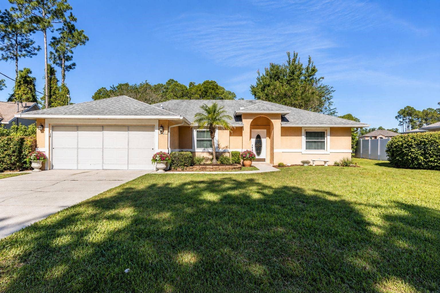 141 BREN MAR LANE, Palm Coast, FL 32137 staged with blooming flowers