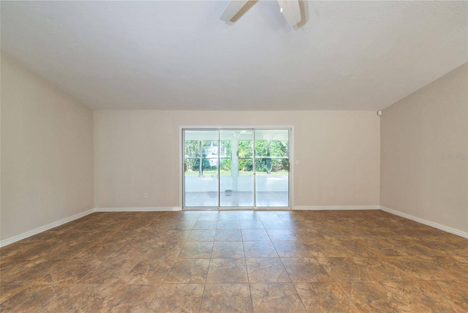 141 BREN MAR LANE, Palm Coast, FL 32137 Living room looking towards the 200 sf Florida room. Triple sliders let in so much natural light.