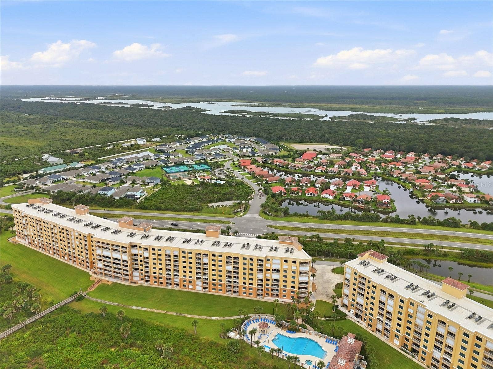 Resort amenities from the air  courts, pool, and the intracoastal beyond.
