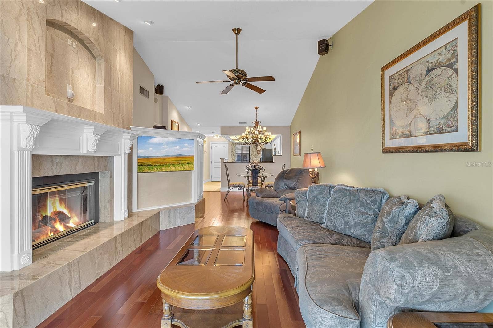 4113 FAIRVIEW VISTA POINT, #311, Orlando, FL 32804 Spacious Living Room Featuring Vaulted Ceilings, Wood Flooring, Custom Built-Ins, and a Beautiful Fireplace