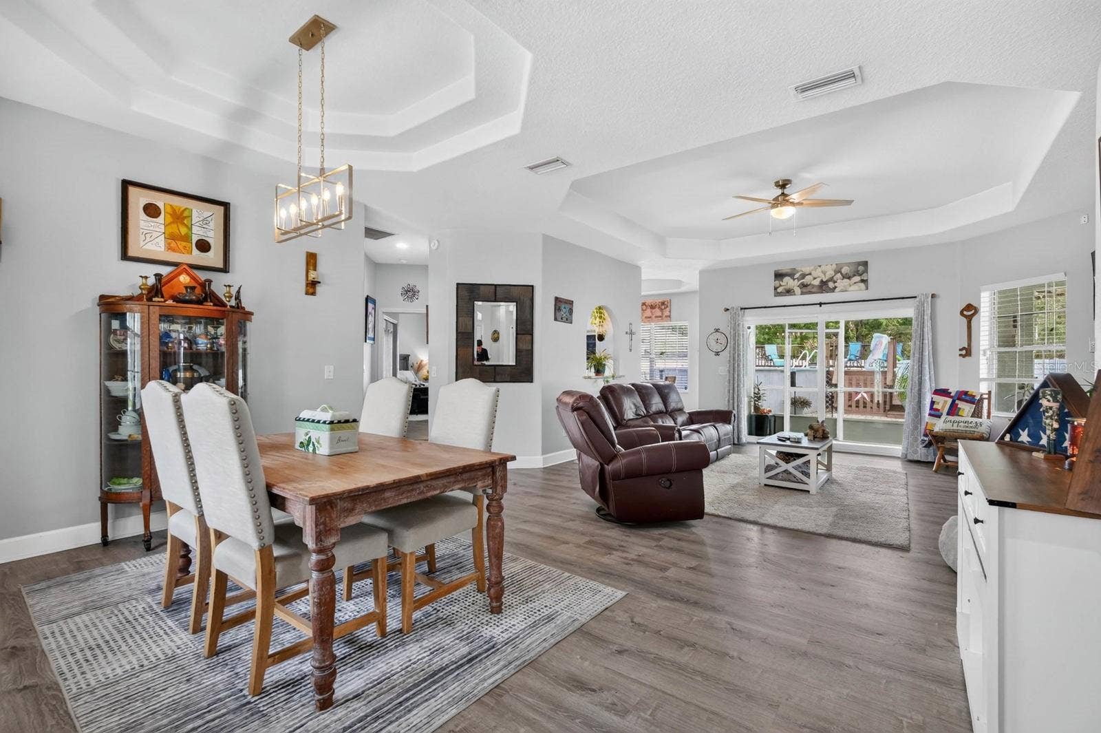72 KARAS TRAIL, Palm Coast, FL 32164 beautiful open dining and living area overlooks backyard with a set of sliders out that go outside to covered and screened lanai