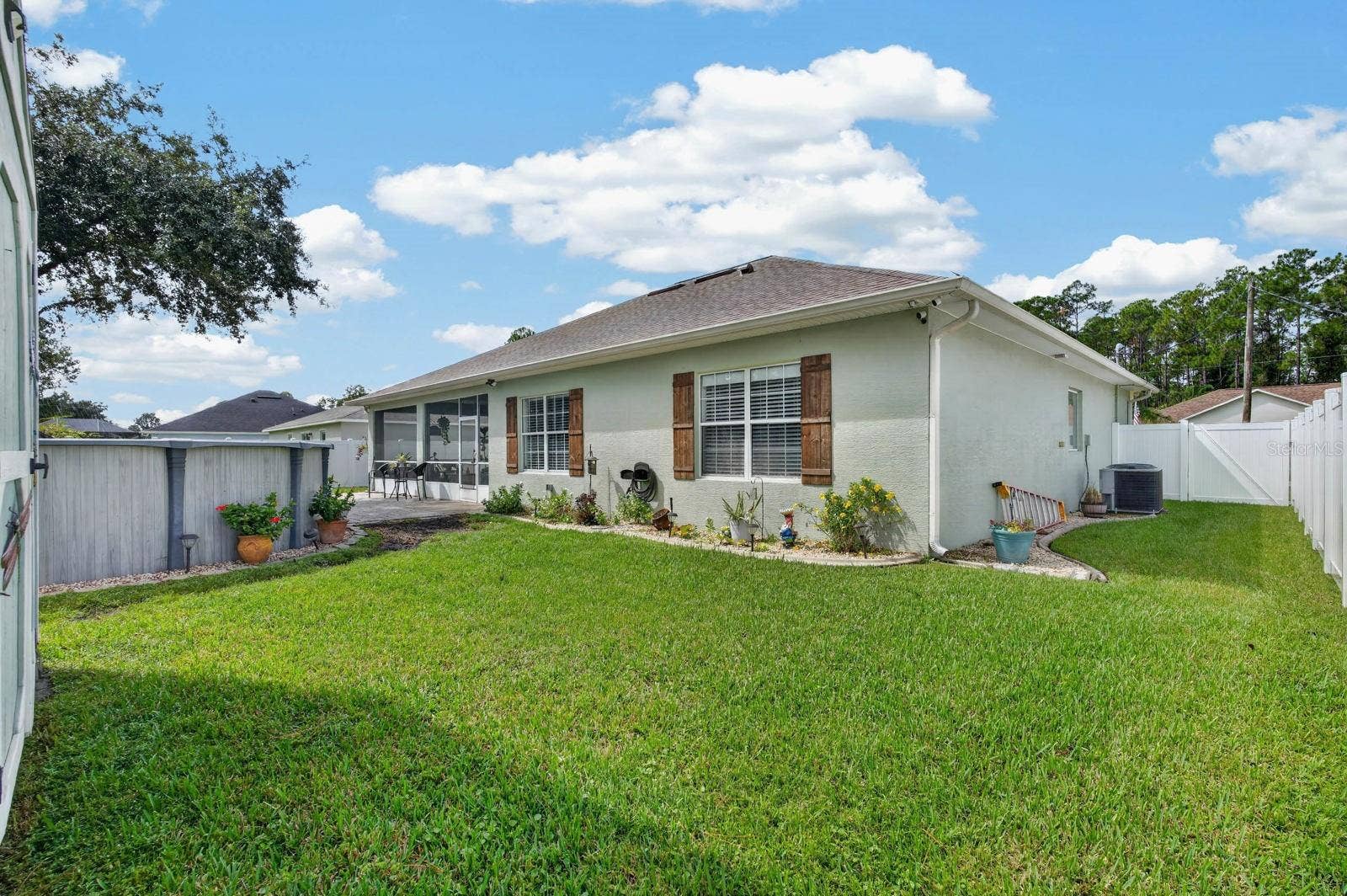 72 KARAS TRAIL, Palm Coast, FL 32164 concrete landscape border and beautiful decorative shutters enhance exterior appeal!