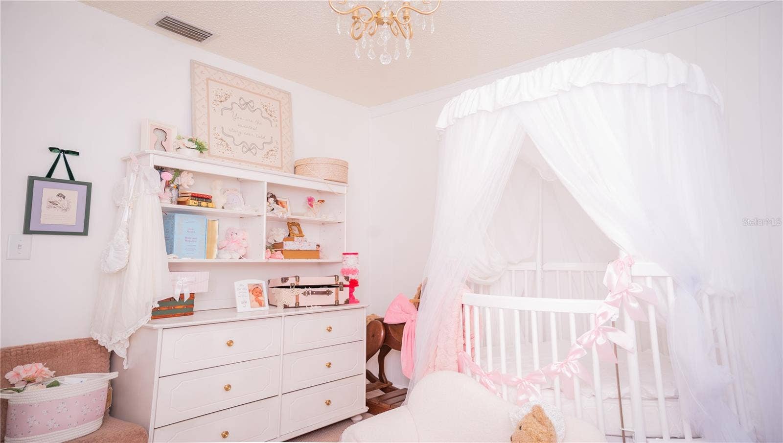 Another view of the nursery, complete with the chandelier ceiling fixture.