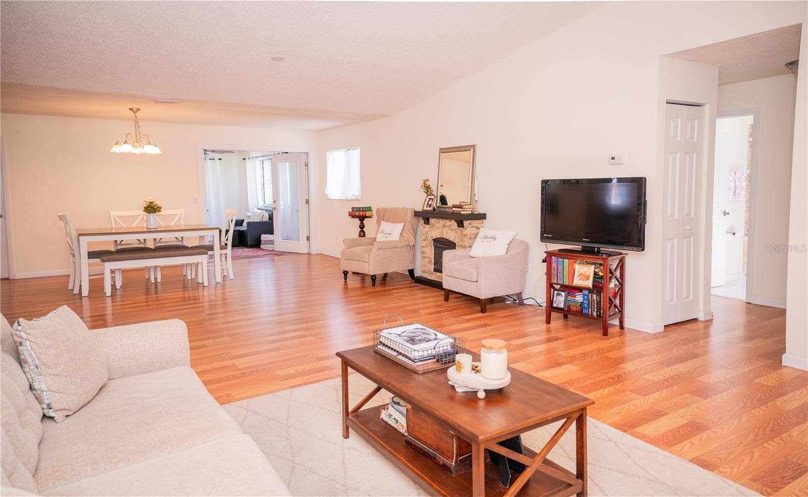 This bright, inviting view highlights the home's natural light, spacious office area, and beautiful plank vinyl flooring.