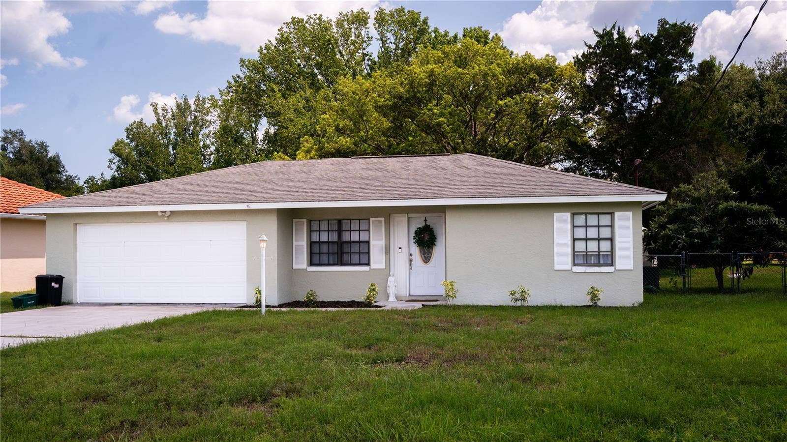 Front view of the house, showing off the exterior, yard, and driveway.