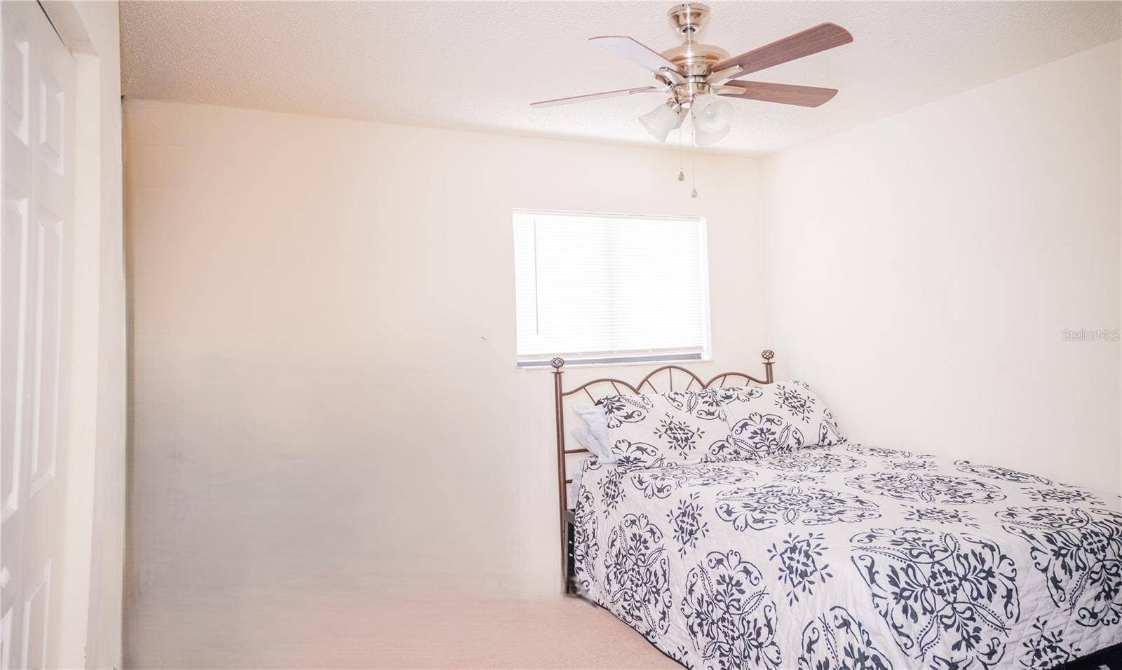 Third bedroom, currently staged as a guest suite.