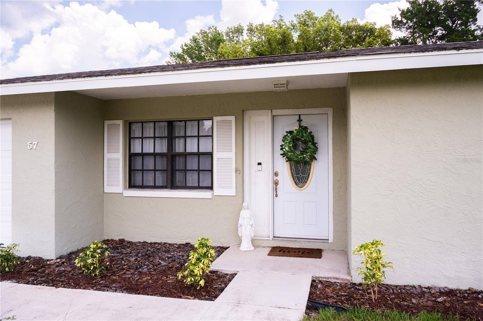 Front entrance featuring a view of the front door and integrated Ring security system.