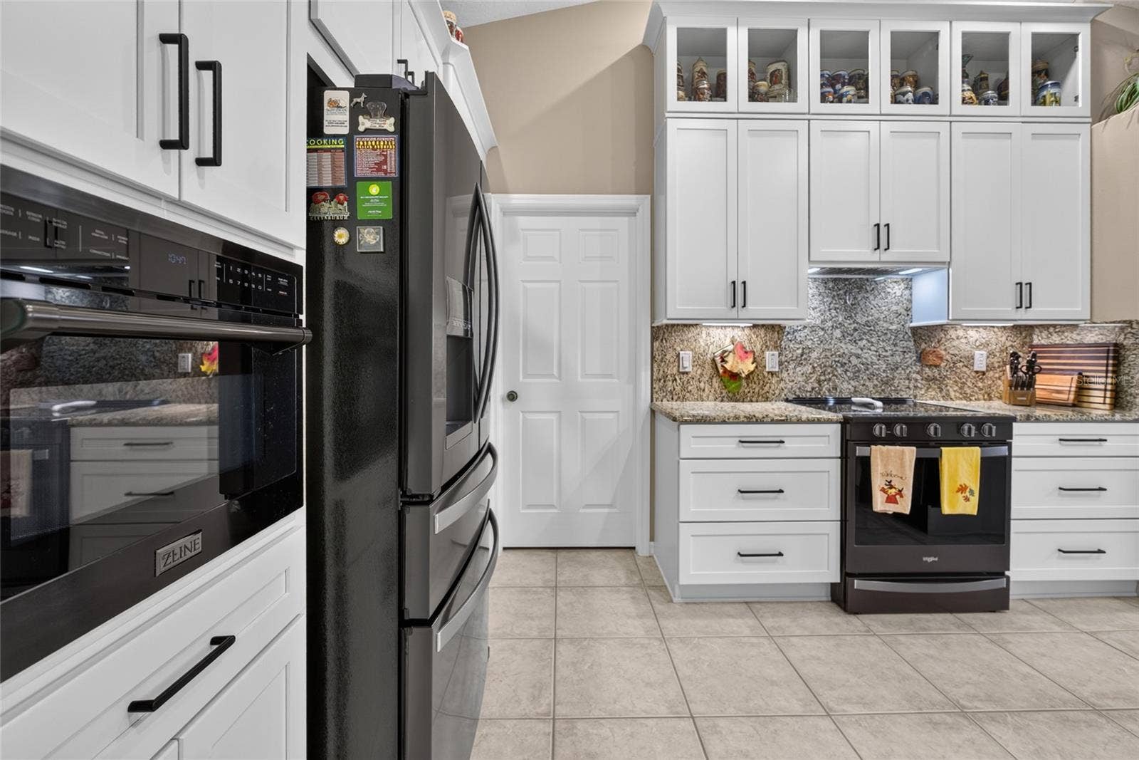 110 BURROUGHS DRIVE, Palm Coast, FL 32137 Kitchen with beautiful granite counters and backsplash.