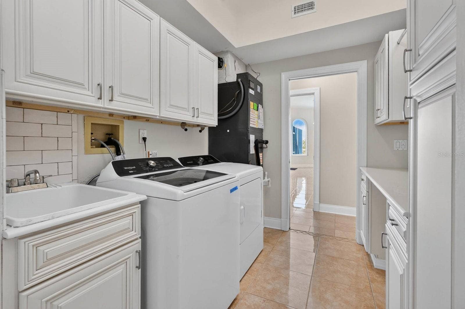 74 COVINGTON LANE, Palm Coast, FL 32137 Laundry Room With Storage Cabinets