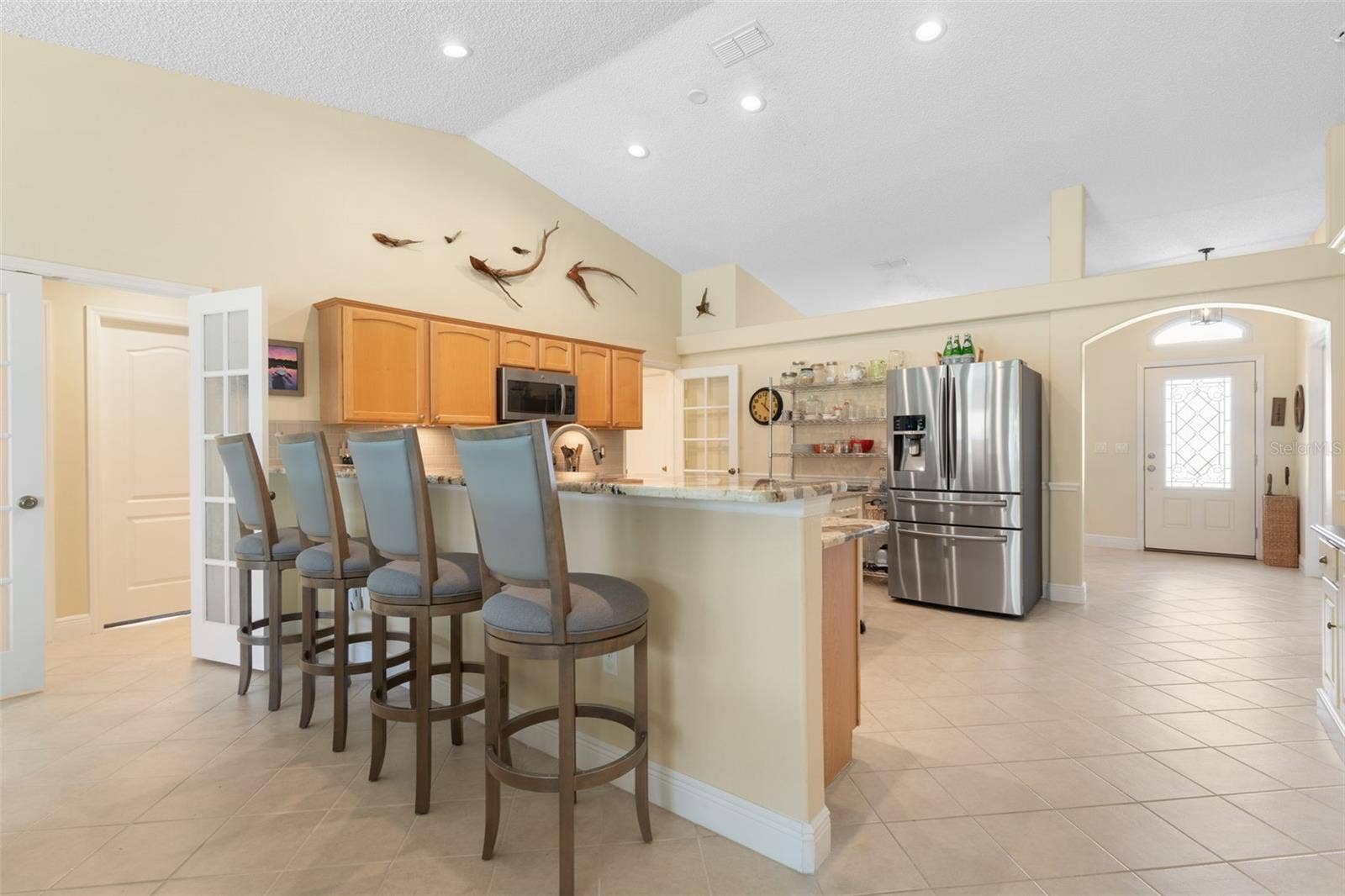 The extended granite breakfast bar offers seating for four, creating a stylish alternative to traditional dining with plenty of counter space for everything from a leisurely brunch to an evening appetizer spread.