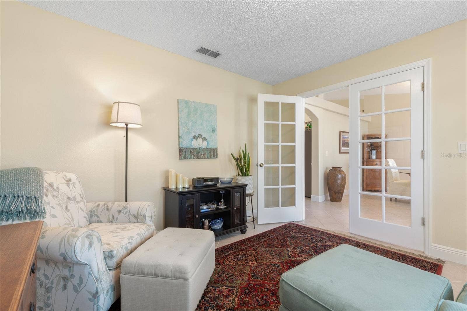 Beautiful French doors provide the option for privacy or an open connection to the rest of the home, making this delightful room equally suited for a productive workday or a little well-deserved downtime.