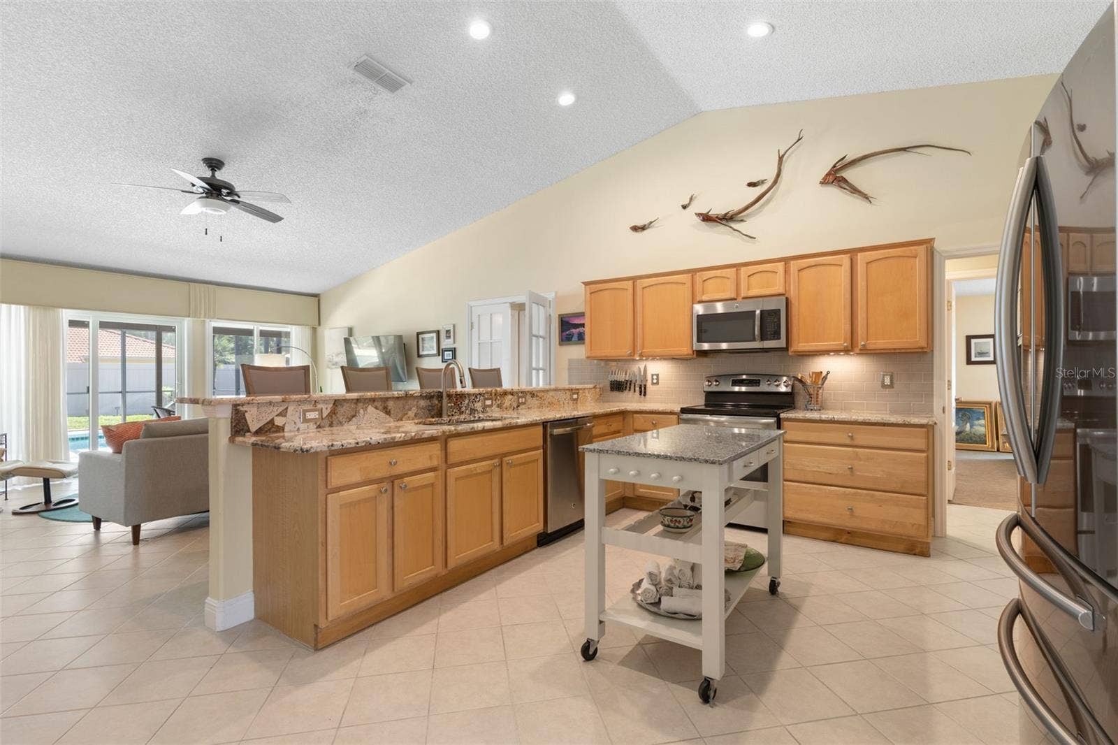 Whether you're preparing a quick breakfast or hosting friends, this kitchen keeps you connected to the conversation! The breakfast bar overlooks the living area, creating a wonderful setting for casual meals and effortless entertaining.