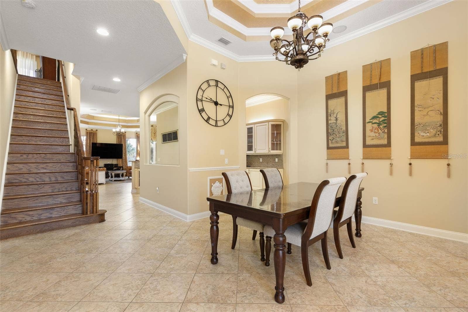 25 EMERALD LAKE COURT, Palm Coast, FL 32137 A beautifully appointed dining room with an elegant tray ceiling, decorative chandelier and architectural details that create a memorable setting for gatherings.