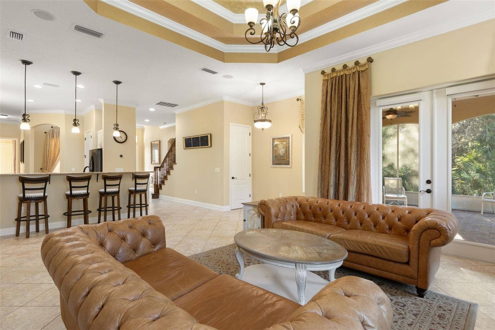 25 EMERALD LAKE COURT, Palm Coast, FL 32137 French doors open to the screened lanai, while the adjoining kitchen and breakfast bar create a natural flow for everyday living and entertaining.
