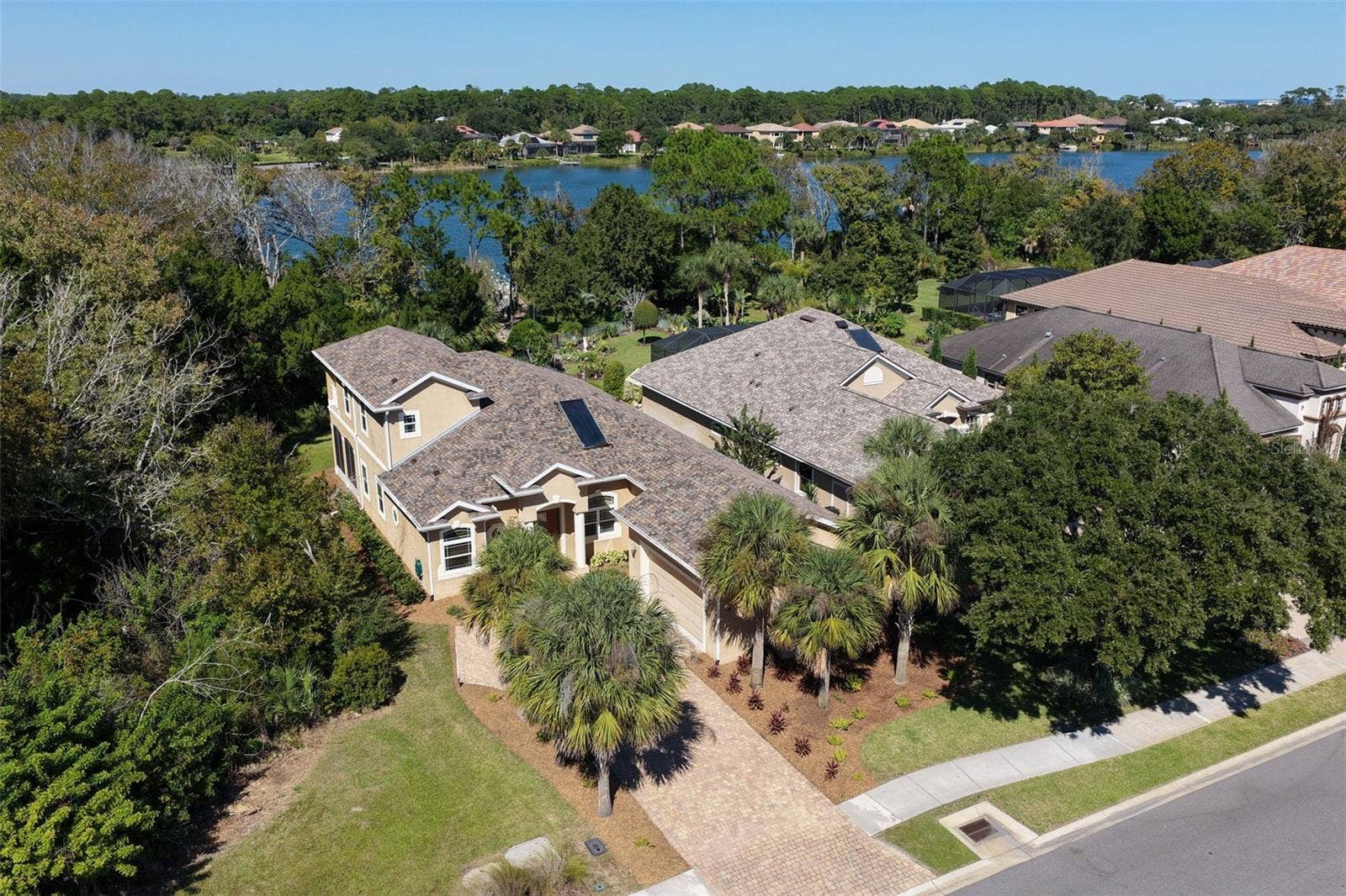 25 EMERALD LAKE COURT, Palm Coast, FL 32137 Distinctive architectural design, lush landscaping, and a paver driveway, with Emerald Lake providing a beautiful backdrop to this Palm Coast Plantation home.