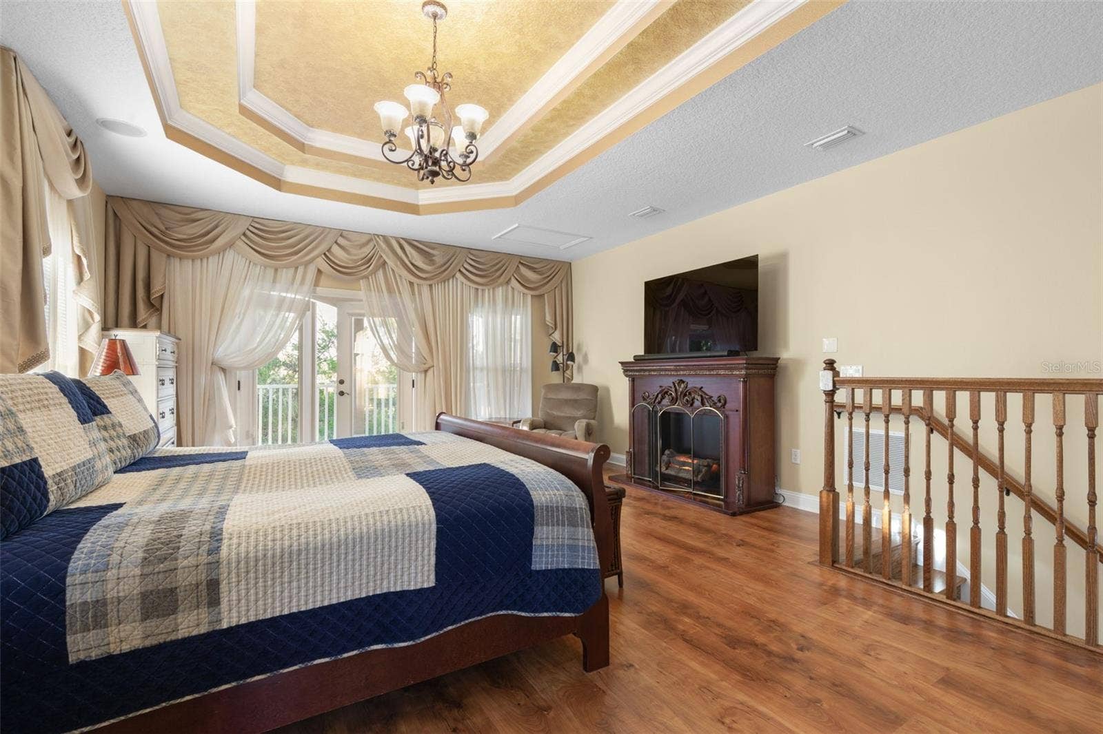 25 EMERALD LAKE COURT, Palm Coast, FL 32137 French doors open to a private balcony overlooking the wooded surroundings, offering a peaceful escape just steps from the bedroom.